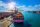 Aerial view of cargo ship and cargo container in harbor.